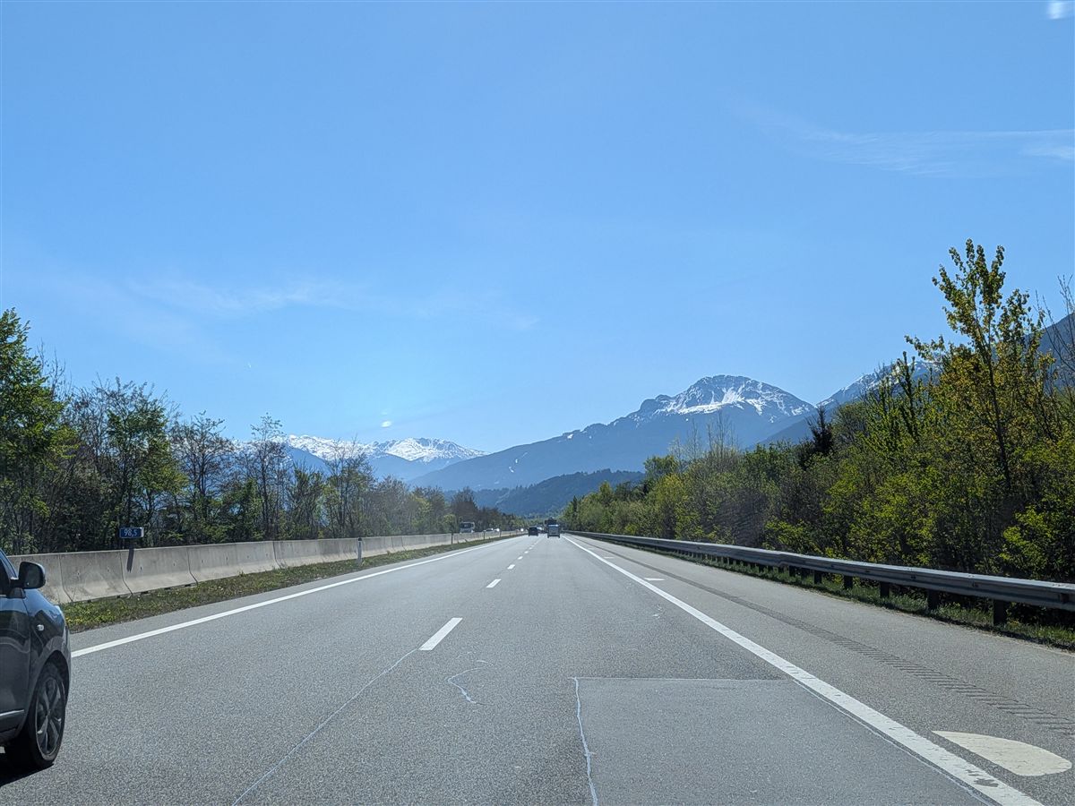 Austrian motorway with snow-capped Alps in the background